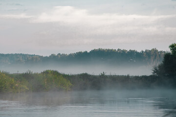 Obraz na płótnie Canvas Morning landscape, sunrise and fog over the river and field.