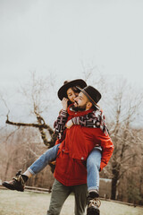 Loving couple walking on the mountain outdoors. Man and woman travel together. Couple traveler enjoys nature, hugs,