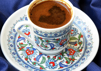 a cup of Turkish coffee on fabric background