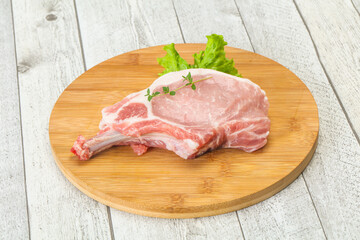 Raw pork bone steak over wooden