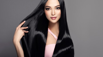 Beautiful asian model girl with shiny black and straight long hair . Keratin straightening ....