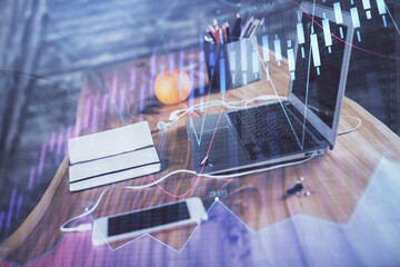 Stock market graph and table with computer background. Double exposure. Concept of financial analysis.
