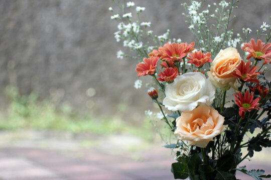 Bouquet of peach and white flowers background with copy space for your text message and any design idea. Floral background for mothers day concept, thank you card, or for any inspirational words.