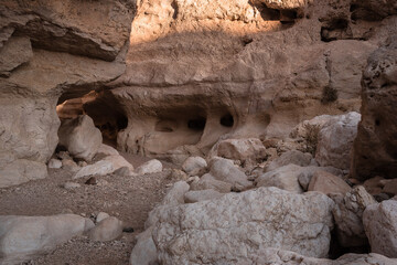 Horseshoe caverns in Crescents Spring (Ein Saharonim) round trek in Ramon Crater (Makhtesh Ramon), at its eastern end, near the small town of Mitzpe Ramon, Ramon Nature reserve, Negev desert, Israel.