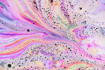 Colorful rainbow bath foam with bubbles in the water. Galaxy imagination. Marble texture effect....