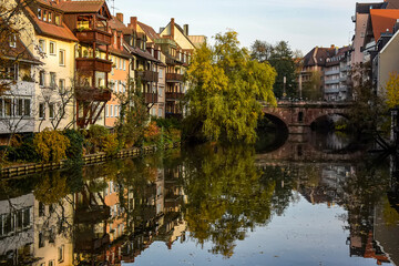 Fototapeta na wymiar A colourful view of the old houses on the banks of the Pegnitz river in Nuremberg, Bavaria, Germany. October 2014