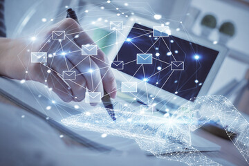 E-mail abstract envelop drawing over hands taking notes background. Concept of electronic mail....