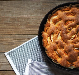 Top view. Round apple pie or biscuit on a wooden rustic table with fresh apples. Homemade healthy...