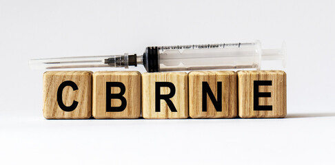 Text CBRNE made from wooden cubes. White background
