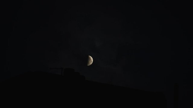 Half moon in the night with clouds