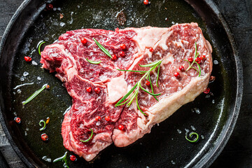 Closeup of red meat with rosemary ready to grill