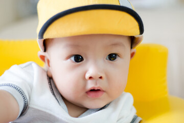 little kid in a yellow cap