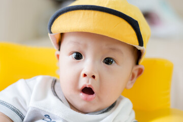 little kid in a yellow cap