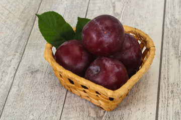 Plum heap in the wooden basket
