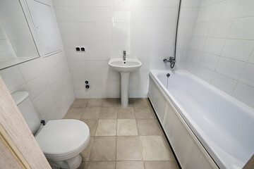 Small new bathroom with toilet, sink, bathtub