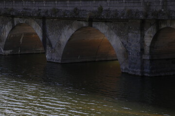 Fototapeta na wymiar Stone bridge over a river
