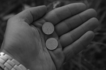 Pair of coins in a man's hand