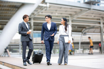 Business people walking down the stairs in the street, while talking and laughing