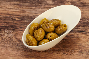 Green grilled olives in the bowl