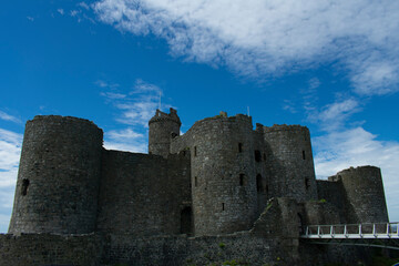 Fototapeta na wymiar Wales, the historic seaside town of Harlech. The imposing medieval castle. The gateway to the monument with rounded defensive towers and walls.