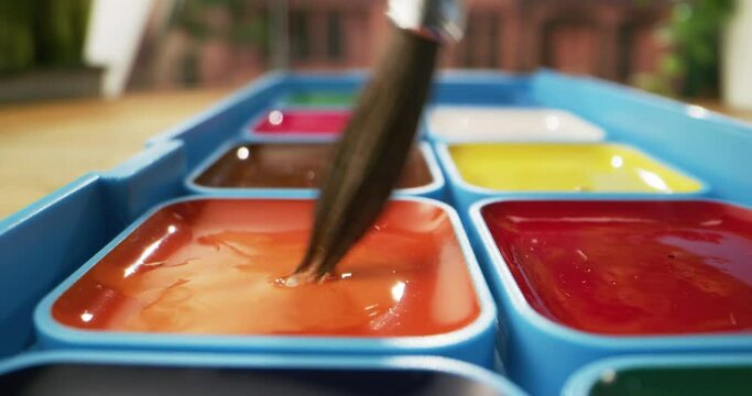 Brush mixing water to watercolor paint