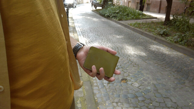 Close Up Male Hands Holding Empty Leather Wallet Looking Inside For Money.