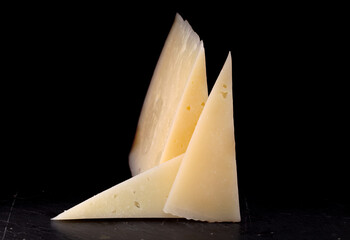 Hard cured sheep cheese from Spain on black slate board