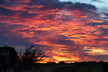 Dramatic clouds at sunset after a storm with orange and purple