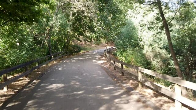 Point of view shot of riding a bicycle at Amarante Cycling Trail in Portugal. Features a wide view of the bike track and the natural scenery as it travels.