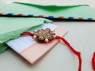 closeup of Rakhee or holy thread with message in envelope on Raksha Bandhan