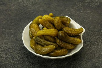 Pickled gherkin in the bowl