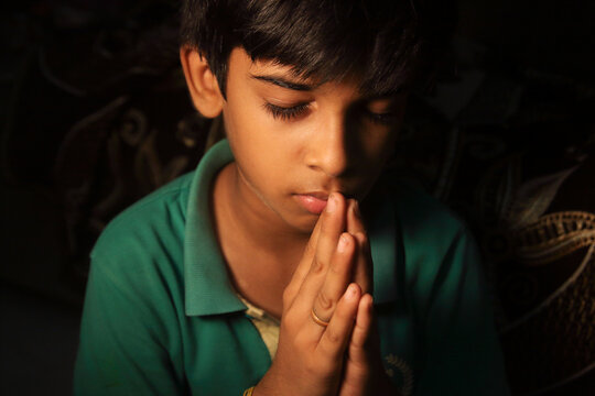 Indian Cute young boy praying	
