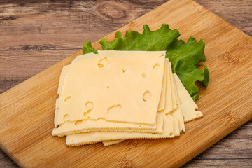 Sliced yellow cheese over board