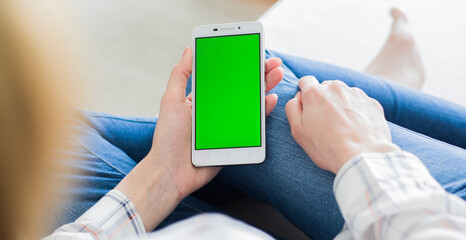 The smartphone in the hands of a young woman	