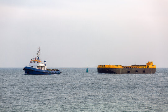 Tug Rope Pulls On The Sea Barge With Sea Sand.