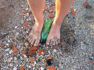 Plastic water bottle thrown at the beach - between your feet