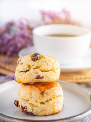 Traditional British scones with a white coffee cup and blurred background