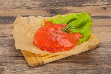 Sliced salmon fillet served rosemary