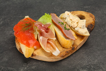Tapas - bruschetta with prosciutto, salmon, duck and gorgonzola