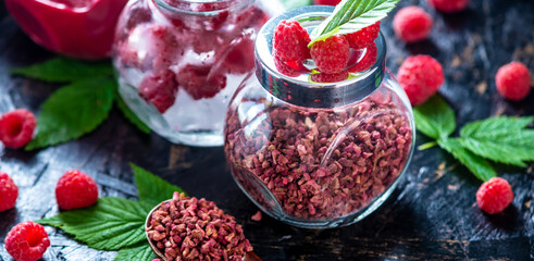 Glass jars with raspberries in different forms. Freeze dried, frozen, and puree. Concept of storage types of berries