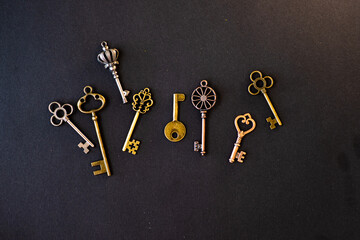Many different old keys from different locks, scattered chaotically, flat lay.
