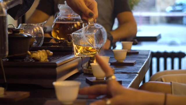 Pouring a High Quality tea while the Traditional Chinese tea ceremony is perfomed by tea master on Tea table - Chaban, Chahai and pial