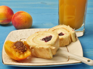 Cream rolls on a plate and apricots and abrix juice