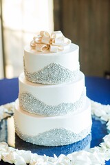 elegant white tiered wedding cake with silver decor