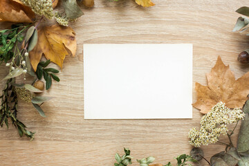 mockup card with autumn leaves. invitation card with environment and details. fall postcard mockup