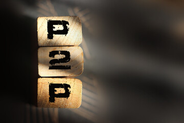P2P abbreviation on wooden blocks. Peer to peer business concept