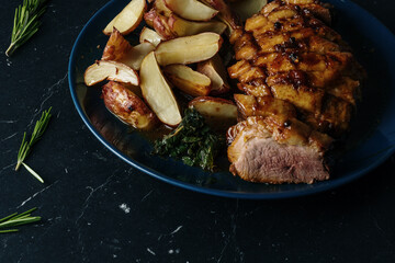 Marinated duck breast with baked potatoes, mint salad and orange sauce