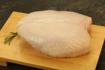 Raw whole chicken breast with skin