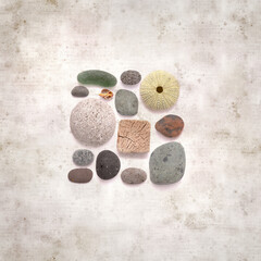 Obraz na płótnie Canvas textured stylish old paper background, square, with pebbles and beach material 