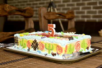 Children's birthday cake decorated with the number five